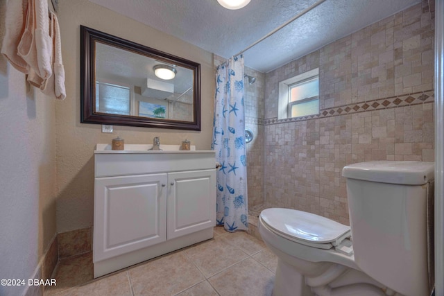 bathroom featuring tile patterned floors, toilet, a shower with curtain, a textured ceiling, and vanity