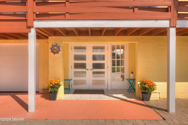 property entrance with a patio and french doors