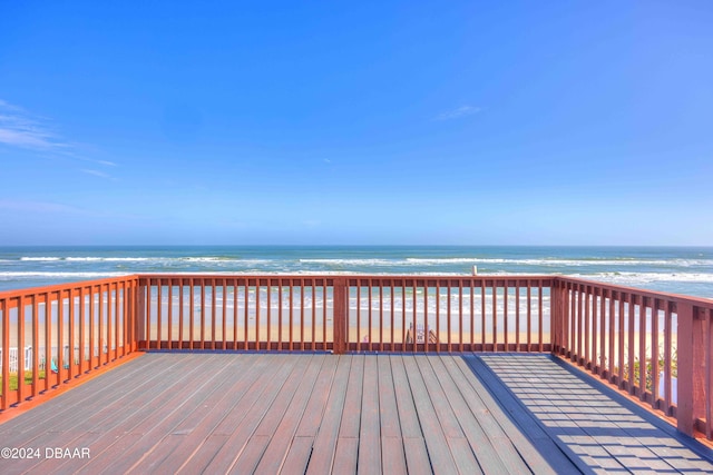 deck featuring a water view and a view of the beach