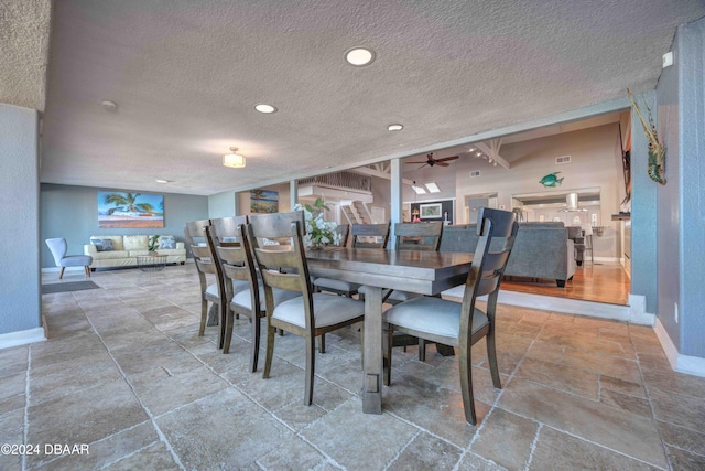 dining area with ceiling fan and a textured ceiling