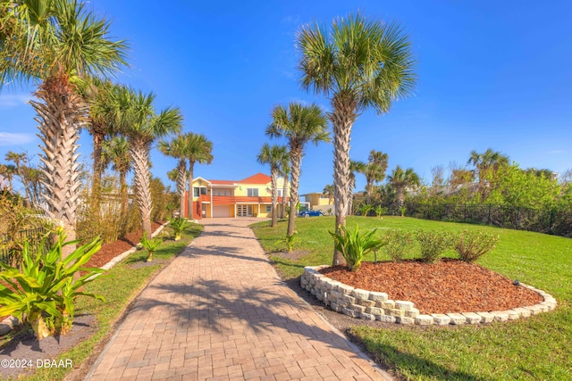 view of home's community featuring a lawn