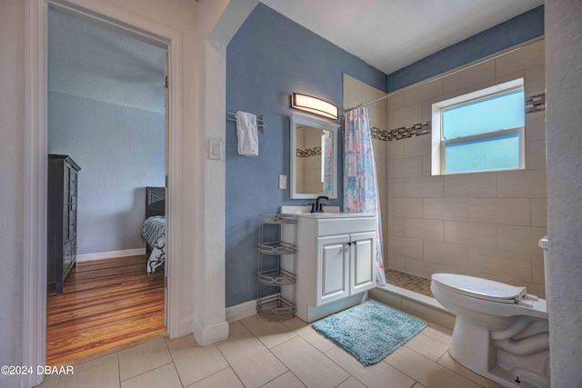 bathroom featuring vanity, hardwood / wood-style flooring, toilet, and a shower with shower curtain