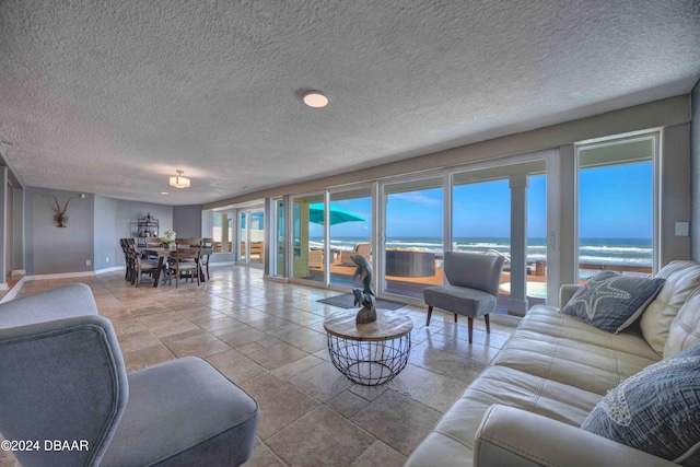 living room with a textured ceiling and a water view