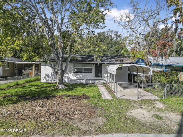 view of front of property with a front yard and a carport