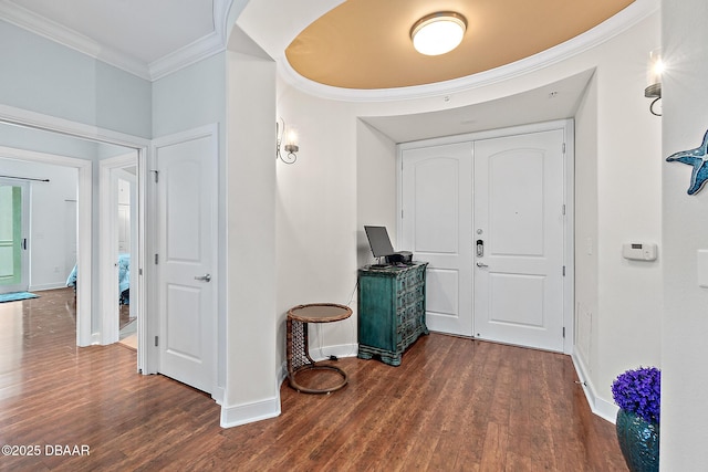 entrance foyer featuring ornamental molding and dark wood-type flooring