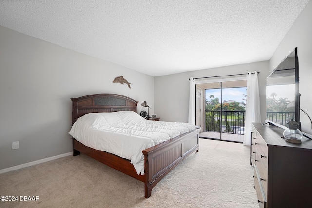 carpeted bedroom with a textured ceiling and access to outside