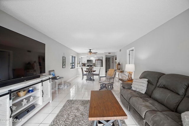 living room featuring light tile patterned floors and ceiling fan