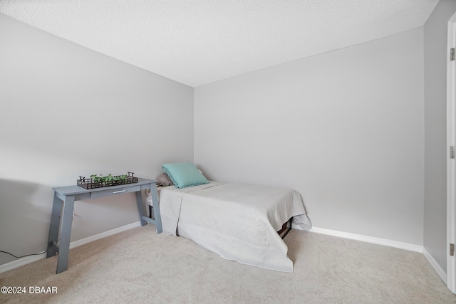 carpeted bedroom featuring a textured ceiling