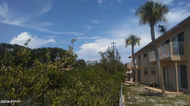 3600 S Peninsula Dr Unit 13, Port Orange, FL 32127 - view of yard with a balcony and a patio