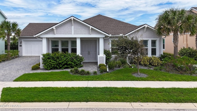 craftsman inspired home featuring a garage and a front yard