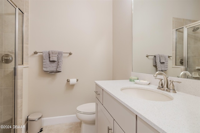 bathroom with toilet, vanity, tile patterned flooring, and walk in shower