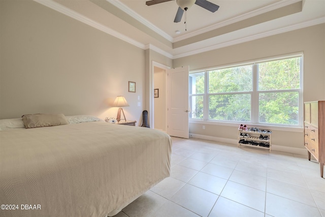 bedroom with ceiling fan, crown molding, a tray ceiling, and light tile patterned floors