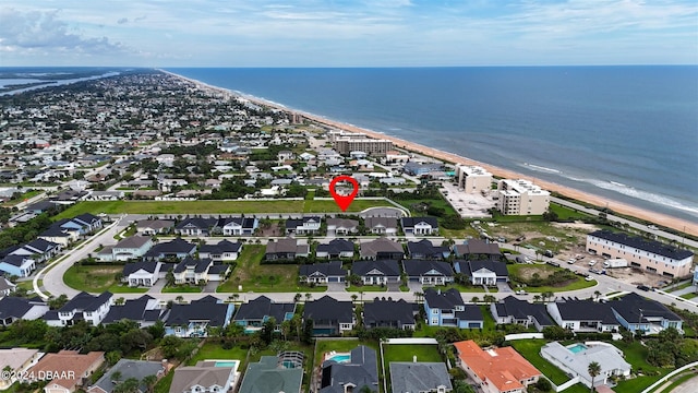 aerial view with a water view and a view of the beach