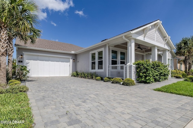 view of front of property with ceiling fan, a porch, and a garage