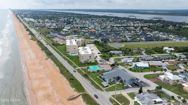 birds eye view of property with a view of the beach and a water view