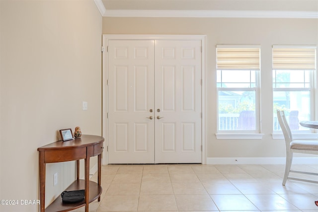 tiled foyer entrance featuring ornamental molding