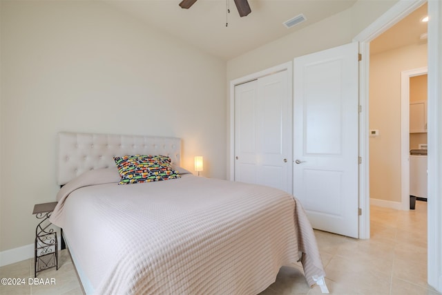 bedroom with light tile patterned flooring, ceiling fan, and a closet