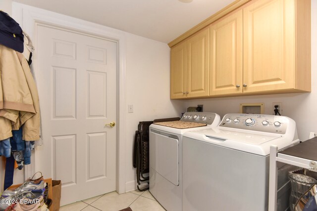 washroom featuring cabinets, independent washer and dryer, and light tile patterned floors