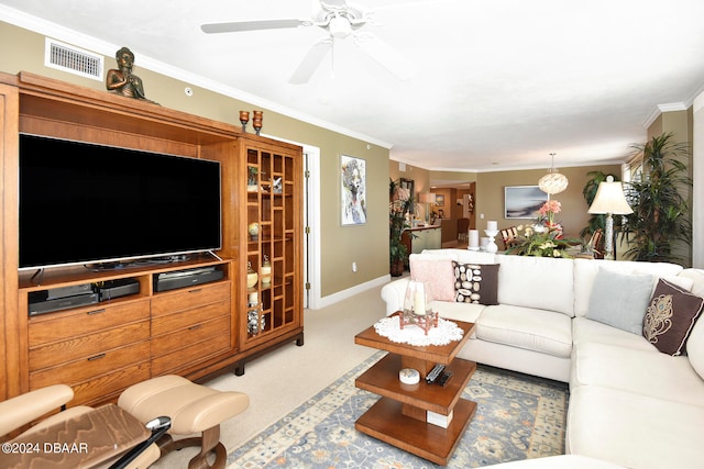 living room featuring ornamental molding, carpet, and ceiling fan