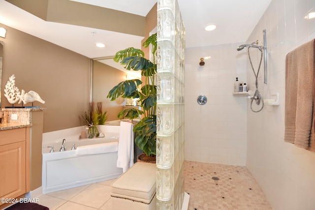 bathroom featuring tile patterned flooring, vanity, and separate shower and tub