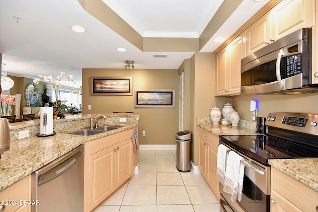 kitchen featuring stainless steel appliances, sink, ornamental molding, light brown cabinetry, and decorative light fixtures