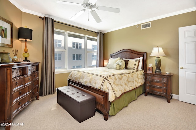 bedroom with ceiling fan, light carpet, and crown molding