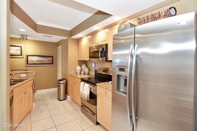 kitchen with stainless steel appliances, sink, light stone counters, ornamental molding, and light tile patterned floors