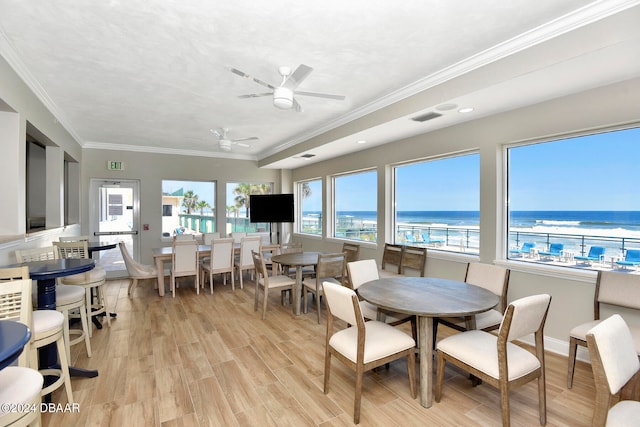 dining space with ceiling fan, light hardwood / wood-style flooring, and crown molding