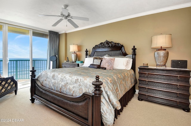 carpeted bedroom featuring ornamental molding, access to exterior, expansive windows, a water view, and ceiling fan