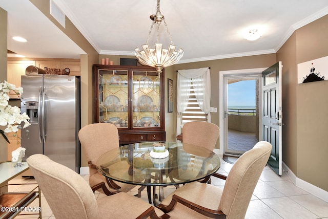 dining space featuring a chandelier, light tile patterned floors, and crown molding