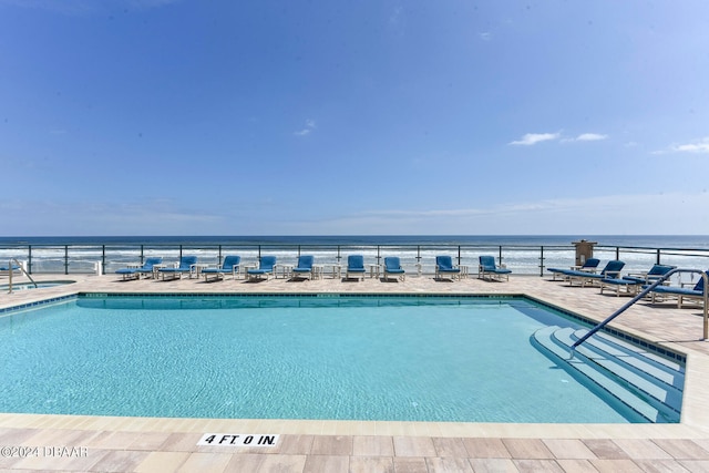 view of pool with a water view