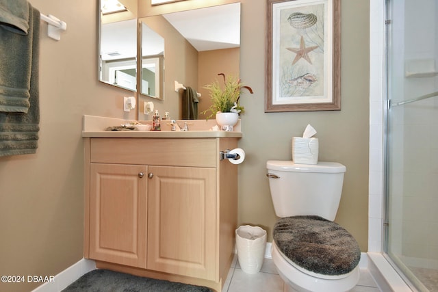 bathroom featuring toilet, an enclosed shower, vanity, and tile patterned floors