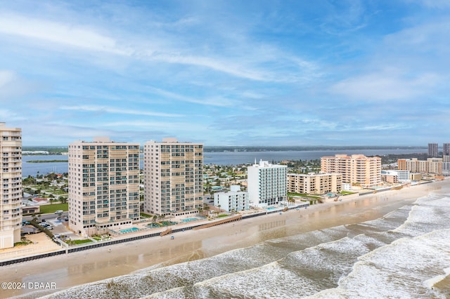 aerial view with a water view and a beach view