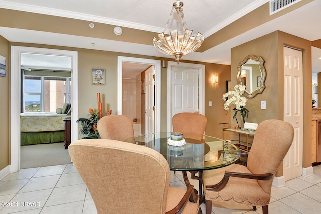 tiled dining space with a chandelier and ornamental molding