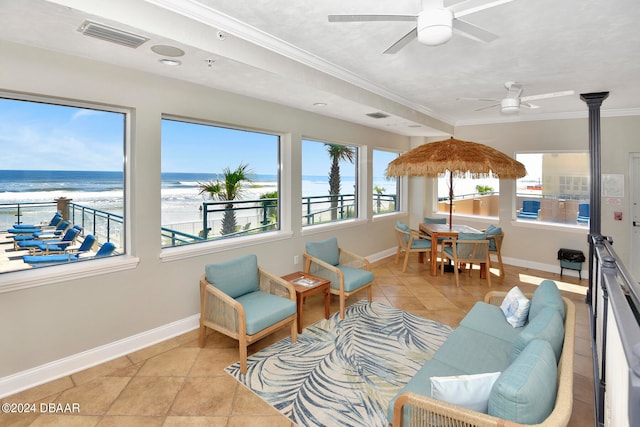 sunroom / solarium with a water view and ceiling fan