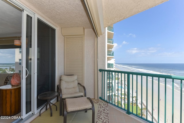 balcony with a view of the beach and a water view