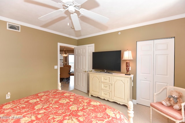 carpeted bedroom featuring ceiling fan with notable chandelier and crown molding