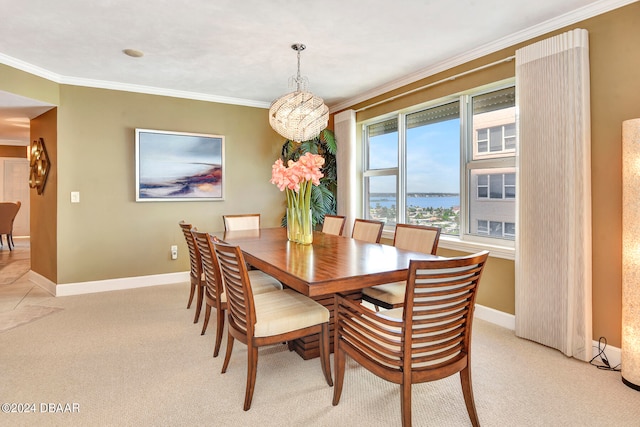 dining area featuring light colored carpet, a notable chandelier, and crown molding