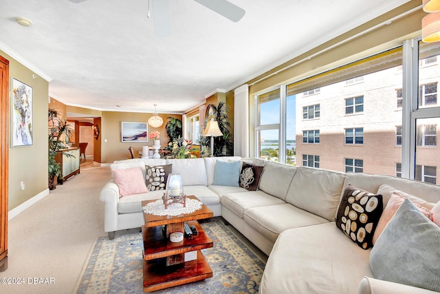 living room with carpet, ceiling fan, and crown molding