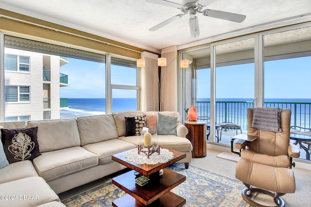 sunroom / solarium featuring ceiling fan, plenty of natural light, and a water view