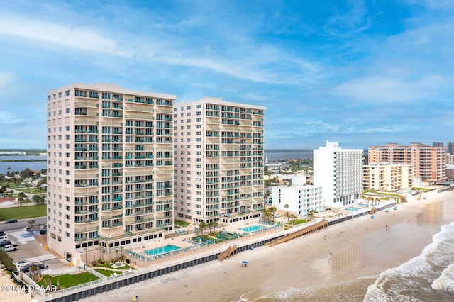 view of property featuring a beach view and a water view