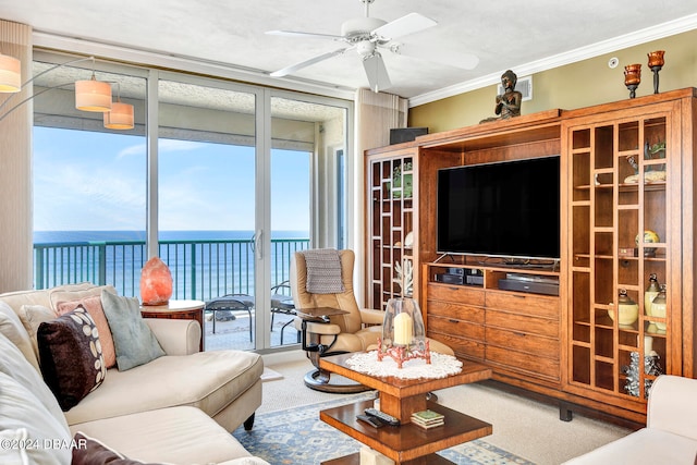 carpeted living room with ceiling fan, floor to ceiling windows, and ornamental molding