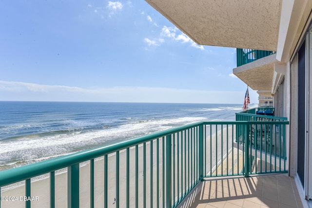 balcony featuring a water view and a view of the beach