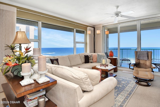 carpeted living room featuring ornamental molding, a water view, and a healthy amount of sunlight