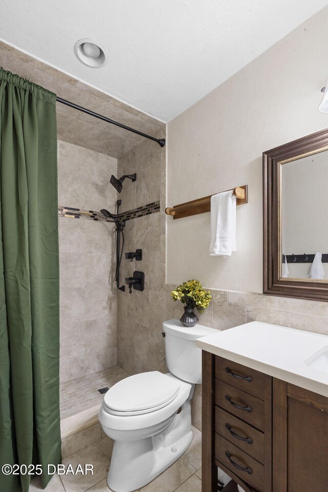 552 Hamlet Dr, Port Orange, FL 32127 - bathroom with tile walls, a tile shower, vanity, and tile patterned flooring