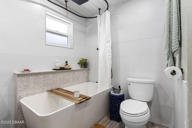 552 Hamlet Dr, Port Orange, FL 32127 - full bathroom featuring a tub, tile walls, a shower with shower curtain, and wood finished floors
