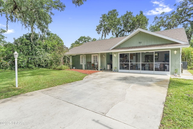 552 Hamlet Dr, Port Orange, FL 32127 - ranch-style house with a front lawn, roof with shingles, concrete driveway, and stucco siding