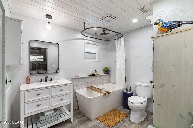 552 Hamlet Dr, Port Orange, FL 32127 - full bathroom featuring a freestanding tub, vanity, wood ceiling, wood finished floors, and a shower with shower curtain