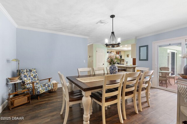 552 Hamlet Dr, Port Orange, FL 32127 - dining area with wood finished floors, a chandelier, and ornamental molding
