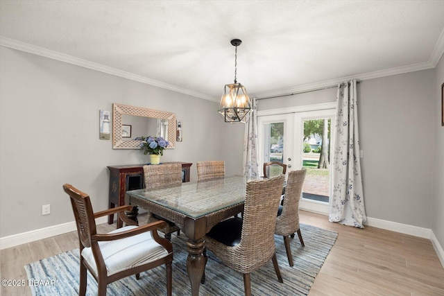 dining room featuring light wood-type flooring, french doors, baseboards, and a chandelier